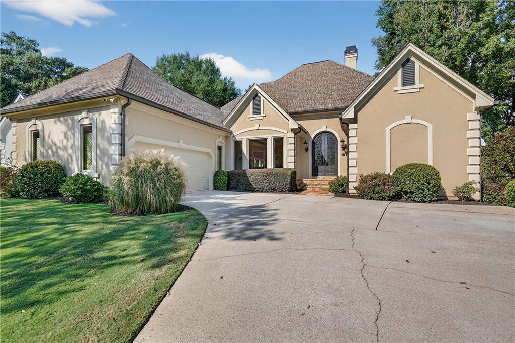 Welcome home to GATED St Ives Country Club in the heart of Johns Creek, just voted #1 city in the US to live in by US News & World Report!!!! Tucked on a quiet CULDESAC with breathtaking GOLF COURSE VIEWS of the first hole, 127 Villamoura Way offers a rare opportunity to own a coveted RANCH WITH FULL FINISHED BASEMENT! You'll be captivated by the large bay windows overlooking the golf course and private, lush backyard immediately upon arrival and instantly impressed by the bright, open floorplan -- a rare find in the neighborhood! Spacious PRIMARY SUITE ON MAIN offers sweeping golf course views plus a generously-sized, spa-like primary bath with granite countertops, separate tub & frameless glass shower, and huge WALK-IN CLOSET with custom closet system! Living room features vaulted ceilings with stone fireplace... kitchen features granite countertops, plentiful cabinet space, generous island, stainless steel WOLF APPLIANCES... breakfast area is the perfect spot to overlook the golf course and enjoy morning coffee... separate dining room offers ample space for entertaining... gorgeous HARDWOOD FLOORS sparkle throughout... spacious laundry room and pantry conveniently located just past kitchen on main floor... terrace level is ideal for entertaining, additional living space, office, you name it! Three spacious bedrooms on the terrace level, two full baths, and two separate living areas... the opportunities are endless! Terrace level provides direct access to lower-level patio, flat, grassy backyard, and golf course! Stunning views of the golf course from the terrace level! The opportunities are endless in this home in coveted St Ives... minutes to top-rated schools, restaurants, shopping, parks, and more!!! St Ives Country Club is a Premier Gated Club Community offering an 18-hole Golf Course, Bars and Restaurants, a Tennis Center with both Clay and Hard Courts, as well as Pickleball Courts. Club membership is separate from the HOA. Don't miss your chance to call this house home!