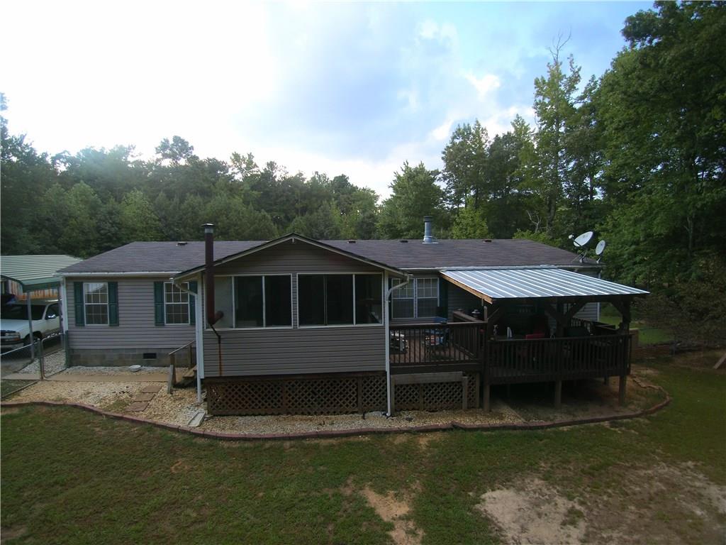 MINI FARM! A must see to believe! Property has 2 additional finished buildings with electric and water, a wood/mower shed, greenhouse, chicken coup, FRUIT trees galore, 2 parking awnings and a deer processing stand. Wood burning stove on covered, screened in porch with separate covered deck. Complete privacy waiting for it's new owners!