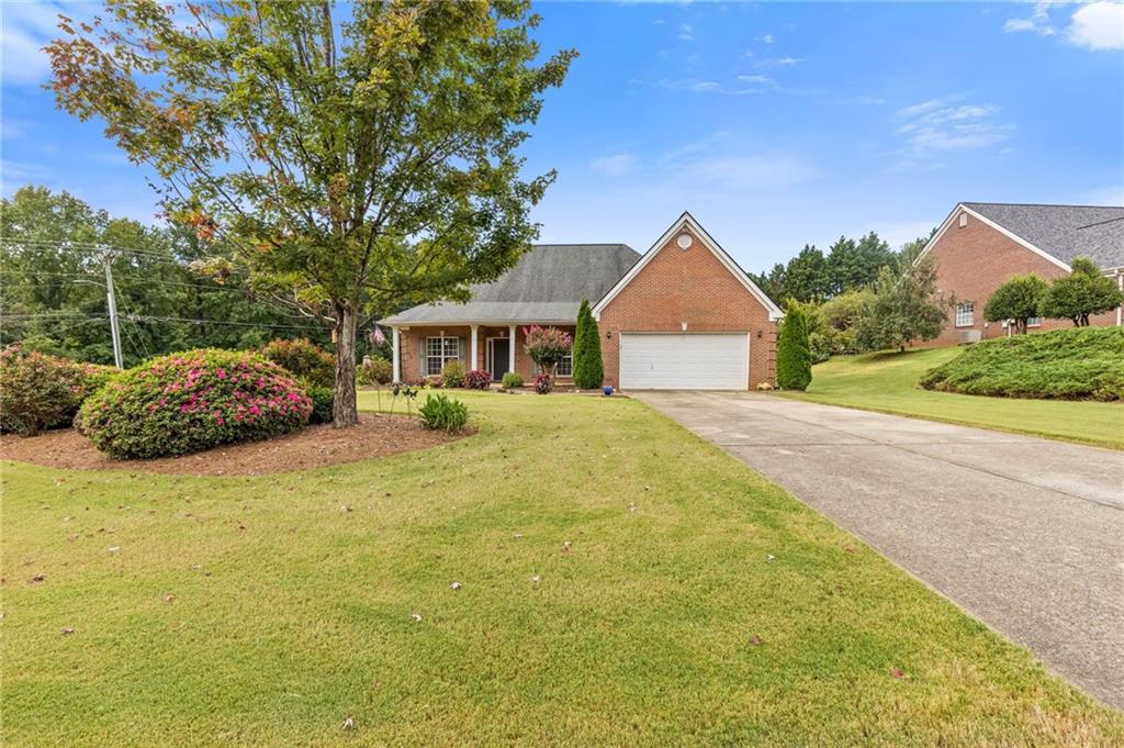 Charming 3-Sided Brick Ranch on a Large Corner Lot! This beautifully maintained home welcomes you with a covered front porch and an inviting open-concept floor plan featuring hardwood floors throughout—no carpet! The spacious fireside family room with vaulted ceiling flows into the formal dining room and eat-in kitchen, complete with white cabinetry, stainless steel appliances, pantry, and convenient laundry access (washer and dryer included). The oversized owner’s suite boasts a tray ceiling, walk-in closet, and spa-like bath with double vanity, soaking tub, and separate shower. Two additional bedrooms provide plenty of space for family or guests with a shared bathroom. Relax or entertain in the huge screened-in porch, freshly painted and overlooking the private, fenced backyard. A detached shed offers extra storage. With its perfect blend of comfort and convenience, this home is move-in ready with loads of options on this large corner lot with OPTIONAL HOA!