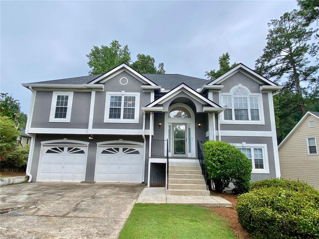 Welcome to 3809 Deercreek Drive, a Multi Level Home with a finished In Law Suite on the Lower level so conveniently located near everything including the Silver Comet Trail, shopping and just about everything! This great priced home offers a Vaulted Great Room with a cozy Fireplace for those cool winter nights (yes, we will have cool evenings again!), a Separate Dining Room with a Vaulted Ceiling and an enhanced Kitchen with Quartz Countertops/ Stainless Steel Appliances including the Refrigerator/ Breakfast Area & plenty of Cabinetry too* From the Breakfast area, you can step out onto the covered back deck which overlooks a fenced yard- perfect for little ones and pets* Stepping Back to other wing of the home, you arrive at the Primary Bedroom with a Trey, or is it a Tray Ceiling, plus you have an En Suite Primary Bath with Double Vanities/ Separate Shower & a Soaking Tub* Plus there is a really good sized Walk in Closet! The other 2 generous sized Bedrooms as well as another Full Bath make up the Main Level* Stepping down the Terrace Level you have a 2nd Kitchen/ Pantry/ Den as well as a 4th Bedroom and a 3rd Full Bath* Plus there is a Laundry Center with a work sink/ Several additional Storage Areas and a 2 car Garage with a workshop area located to back of the Garage* Gas Heat and Gas Water Heater*Updated Flooring too*You will Love how close you are to everything including 1.5 miles to the East West Connector/ 2 minutes to downtown Powder Springs/ 4 minutes to Thornton Road (Hwy 278) which takes you promptly to the Hiram Shopping & Dining District too* Or you may just want to take a spin on the Silver Comet Trail- it is all at your disposal* Come take a look, you will be glad that you did!