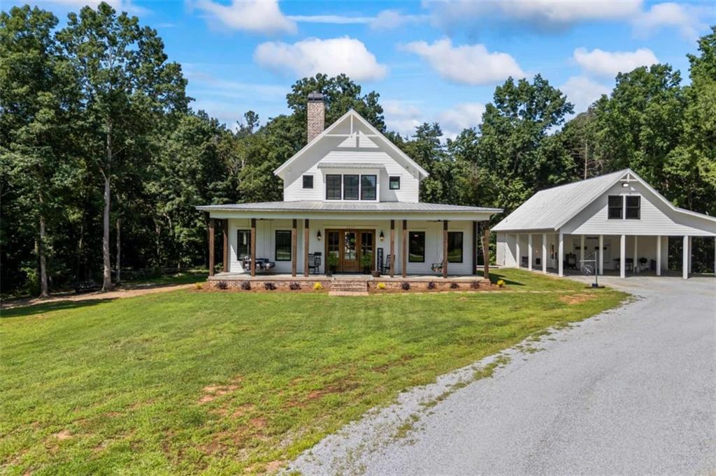 No detail left behind in this custom Banks County Beauty! Nestled on 2.06 acres, this thoughtfully designed home is waiting for you to make it yours. From the moment you walk in, you'll feel the warmth of a space built for gathering-with a spacious main-level primary retreat, open living and dining areas, a gorgeous kitchen, butler's pantry, coffee bar, and laundry room all perfectly laid out for everyday living and unforgettable entertaining. Upstairs, two additional bedroom and bathroom suites give the kids their own space to host sleepovers, decorate their rooms, and create memories. Step out back to a porch big enough for all the BBQs, birthday parties, and summer nights under the stars-plus a yard full of possibilities. Need extra space for hobbies, work, or play? The detached carport and shop offer the perfect "man cave" or "she shed" with its own kitchenette and bathroom, along with plenty of room for tools, toys, and yard gear. All of this, just minutes from downtown Homer, local schools, I-85, and Hwy 365-where shopping, dining, and fun for the whole family are always close by.