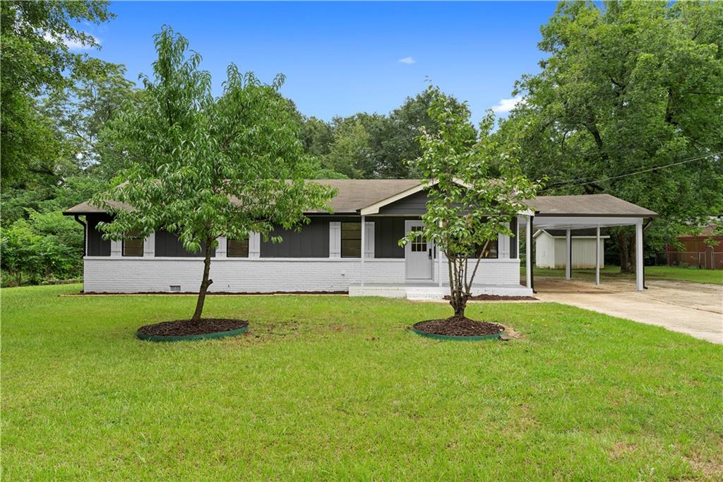 Updated Ranch in McDonough! This 4-bed, 2-bath home is absolutely beautiful. The kitchen features white cabinets, stainless steel appliances, stone countertops, a white tiled backsplash, and trendy gold hardware. The master suite includes an updated bathroom with a new vanity, a standalone tiled shower, and matching gold hardware. The second bathroom has been updated in a similar style. Other highlights include new flooring throughout, a large driveway with a carport, and a backyard with a covered patio.