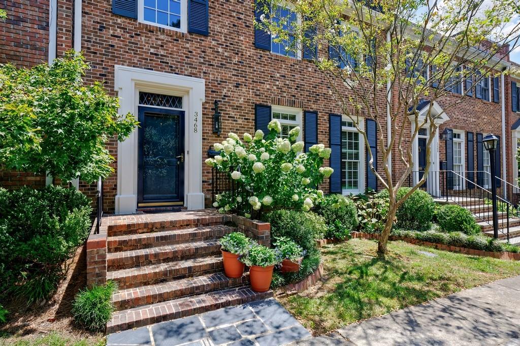 This spectacular designer's townhome was renovated in 2024. It is one of the largest townhomes in Paces Place. This home has a two story foyer with curved staircase, the primary suite is upstairs along with two large guest bedrooms each with en suite baths. All of the bathrooms including the powder room on the main level were fully renovated in 2024. The main level has a formal dining room, currently used as a den. The very large living room has been divided into a living/dining room which has brand new French doors leading to the courtyard. Current owner likes this set up for a better flow for entertaining, but a separate formal dining room is available. Walls were removed in the kitchen to make it open into the breakfast room. The original solid wood cabinetry was saved and updated. New hardwoods were installed in the kitchen and all hardwoods were refinished throughout the home in 2024. New hand forged awnings were installed over the French doors leading to the courtyard. Lucite was used instead of canvas so not to block any light keeping the living room bright. The brick courtyard walls were white washed to also brighten the lovely landscaped patio. The detached two car garage has been newly sheet rocked and already has a half bath--easily ready to be converted into a charming guest house, office, or other. The crawlspace has been professionally encapsulated. The HVAC is brand new. Paces Place is conveniently located to schools, shopping, restaurants, Buckhead and Vinings, and quick access to I-75. This gated community has a dog park, trails, sports court, a wonderful pool, and ample guest parking.