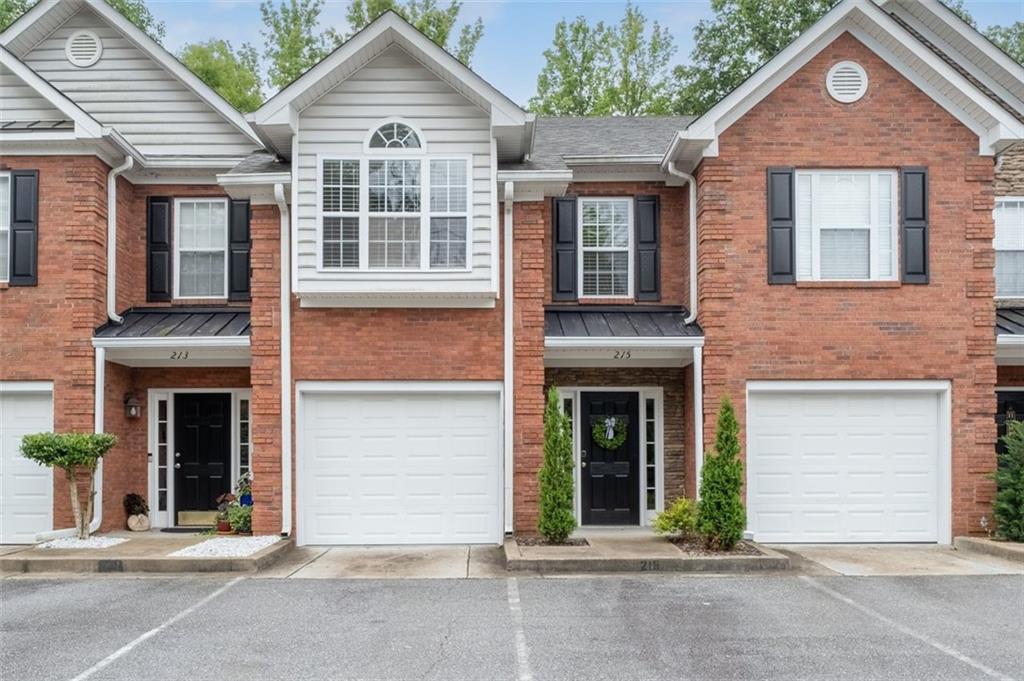 Just minutes from the vibrant heart of Downtown Woodstock and a short drive to Historic Roswell, this impeccably styled townhome is nestled within an exclusive community of just 13 residences, offering a rare blend of luxury, privacy, and convenience. From the moment you step inside, you're welcomed by a bright, open layout featuring rich luxury vinyl flooring, fresh alabaster paint with crisp white trim, and thoughtfully curated designer finishes throughout. The chef-inspired kitchen is a true showstopper, boasting gleaming granite countertops, a deep breakfast bar that feels like an island, stainless steel appliances, a large pantry, and a charming arched entry into the spacious living and dining areas. Step outside to a tranquil, fenced backyard with a spacious patio and privacy screens—perfect for entertaining or unwinding. Upstairs, two expansive bedrooms await, including a stunning primary suite with abundant natural light and a beautifully updated en-suite bath featuring a sleek walk-in shower with frameless glass doors, elegant tile, and granite counters. This beautifully appointed home offers refined living in a prime location—don’t miss the opportunity to make it yours.