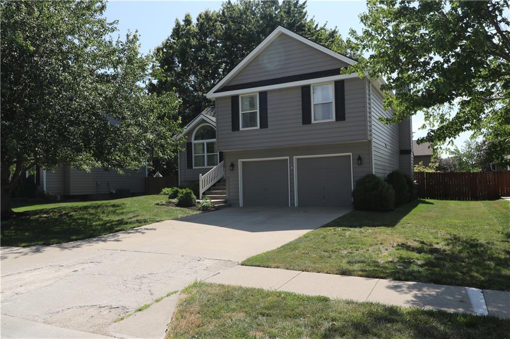 View of front of home featuring a garage and concrete driveway