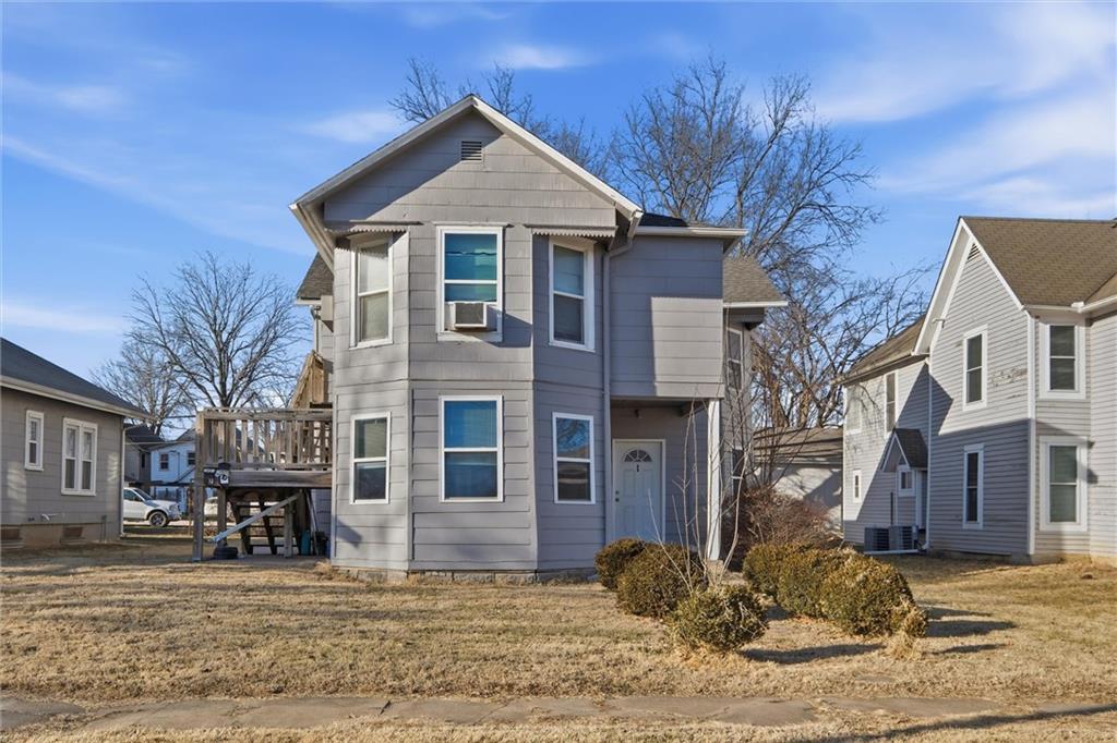 Traditional home with a deck and a front yard