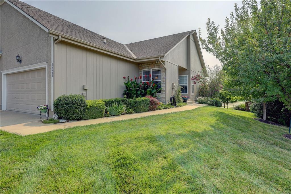 View of side of home with a garage and a yard